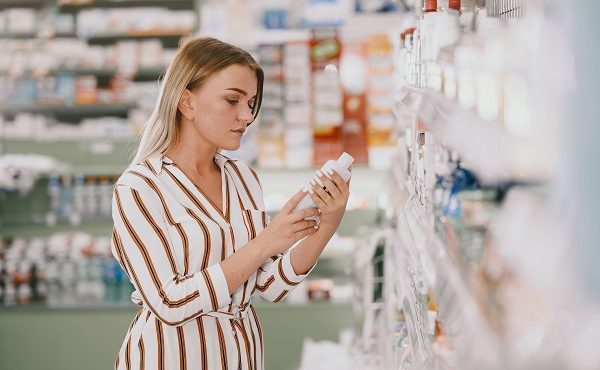 Medicine, pharmaceutics, health care and people concept. Female taking medications from the shelf. Buyer.